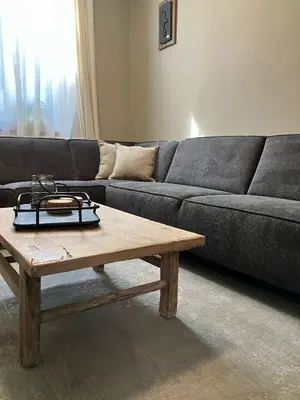 a living room with a couch and a wooden coffee table at Huisje Emma in Tongeren