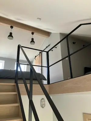 a room with a staircase and a bed in it at Huisje Emma in Tongeren