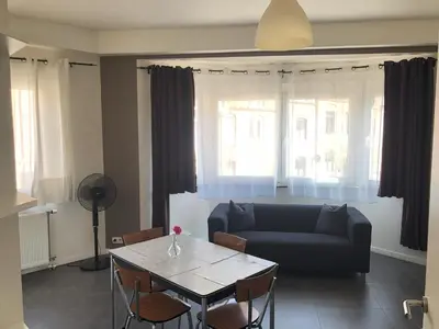 a living room with a couch and a table at Appartement confortable proche centre et idéal pour ULiège Sart Tilman in Liège