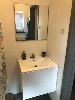 a bathroom with a white sink and a mirror at Appartement confortable proche centre et idéal pour ULiège Sart Tilman in Liège