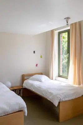 a bedroom with two beds and a window at Land van Engelingen in Helshoven