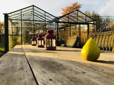 a table with three lights and a pear on the table at Land van Engelingen in Helshoven