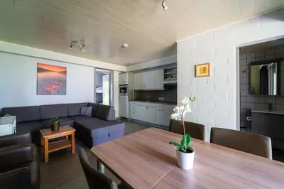 a living room with a table and a couch at Acacia 8 Hengelhoef in Houthalen-Helchteren