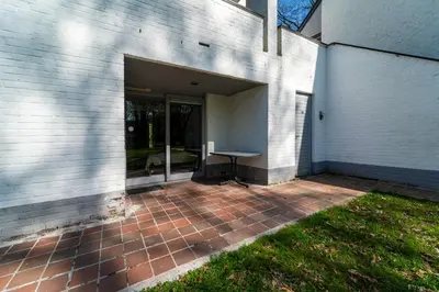 a garage with a table in it next to a building at Acacia 8 Hengelhoef in Houthalen-Helchteren