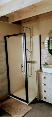a bathroom with a shower and a glass door at 't Herenhoes in Pelt