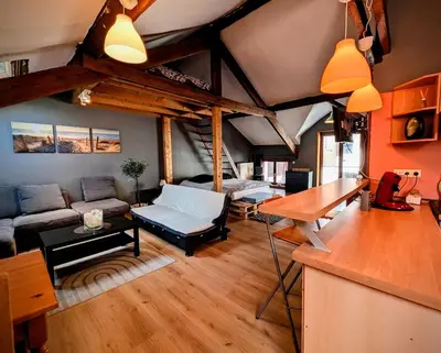 a living room with a couch and a table at La Cachette d 'Amercoeur in Liège