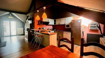 a kitchen with a table and a counter top at La Cachette d 'Amercoeur in Liège
