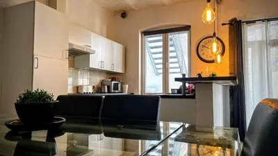 a kitchen with a glass table in a room at Le Rez d'Amercoeur in Liège