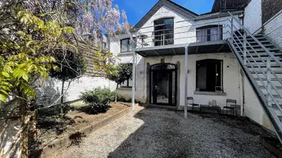 a white house with a staircase leading to the front door at Le Rez d'Amercoeur in Liège