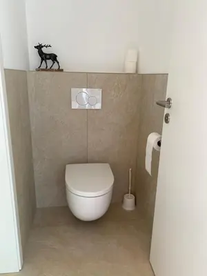 a bathroom with a toilet with a horse on the wall at Weserwasser in Eupen