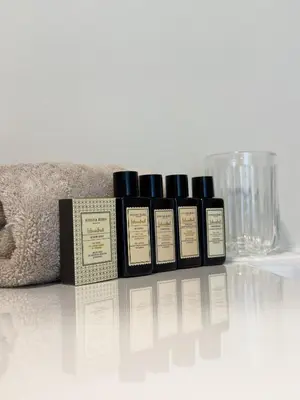 a group of four bottles ofmetics sitting on a table at Genk Central Apartment in Genk