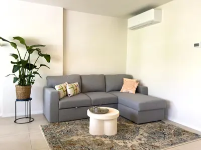 a living room with a couch and a table at Genk Central Apartment in Genk