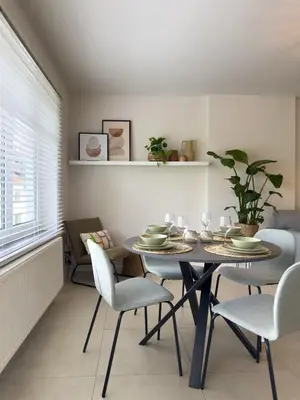 a dining room with a table and chairs at Genk Central Apartment in Genk