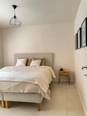 a bedroom with a bed and a side table at Genk Central Apartment in Genk