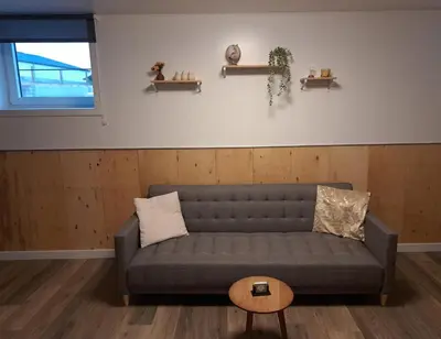 a living room with a couch and a table at B&B Hoeve Terwinghe in Gingelom