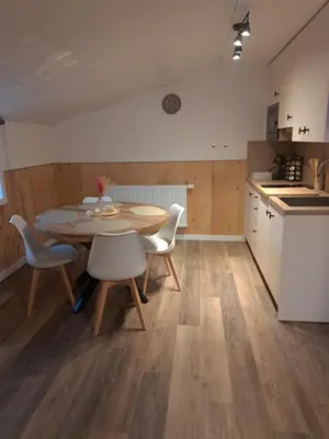 a kitchen and dining room with a table and chairs at B&B Hoeve Terwinghe in Gingelom