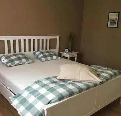 a bed with two pillows on it in a bedroom at Vakantiewoning Huys op de Locht in Scherpenberg