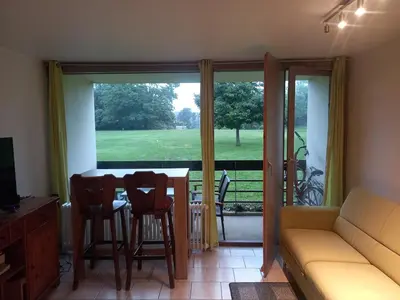 a living room with a couch and a table and chairs at Ap76 Nature Ardennes Economy class apartment in La Calamine