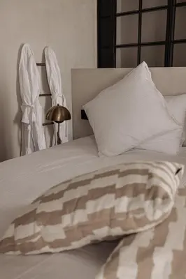 a white bed with a blanket and pillows at Guesthouse Just Be Mine in Beringen