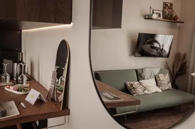 a mirror reflection of a living room with a couch at Guesthouse Just Be Mine in Beringen