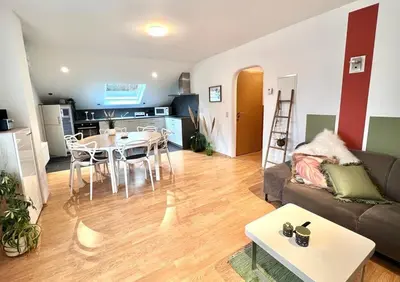a living room with a couch and a table at Au Natur'elle in Gemmenich
