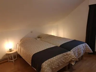 a bedroom with a bed in a room with a lamp at Au Natur'elle in Gemmenich
