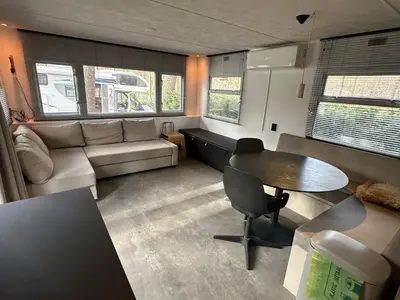 a living room with a table and a couch at Chalet Tibi in Bocholt