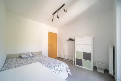 a white bedroom with a bed and a closet at Liège 3 Bedroom Apartment, Quiet and Central in Liège