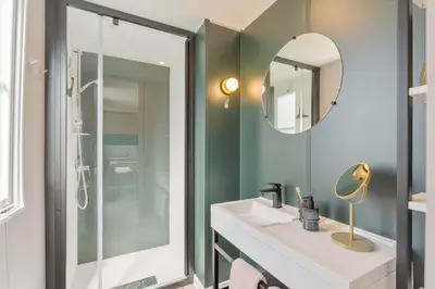 a bathroom with a sink and a mirror at Holiday home La Casetta in Kinrooi