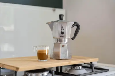 a coffee maker on a counter with a cup of coffee at Holiday home La Casetta in Kinrooi