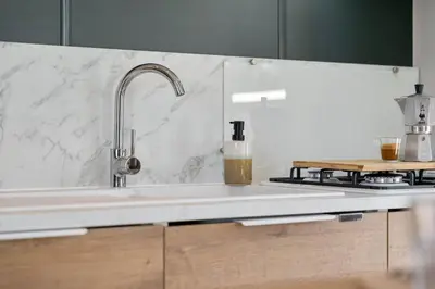 a kitchen counter with a sink and a stove at Holiday home La Casetta in Kinrooi
