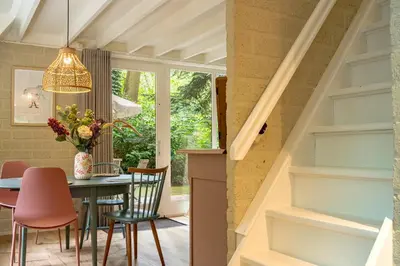 a dining room with a table and chairs at Boshuisje Rekem - Nilsson in Lanaken