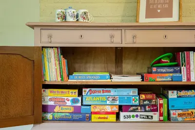 a book shelf filled with lots of books at Boshuisje Rekem - Nilsson in Lanaken
