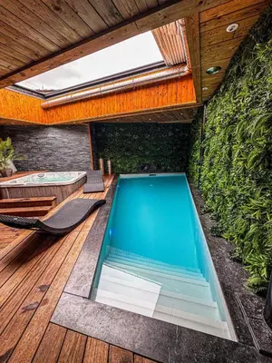 a swimming pool on the deck of a house at Clos des Thermes-Secret Garden in Liège