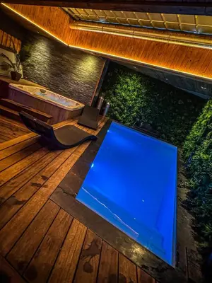 a large screen tv on a wooden deck at Clos des Thermes-Secret Garden in Liège