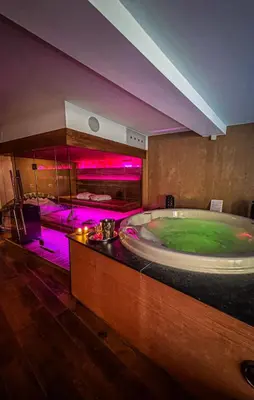 a large bathroom with a jacuzzi tub with purple lights at Clos des Thermes-Zanzibar in Liège