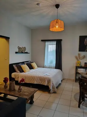a bedroom with a bed and a table at De Smokkelhoeve in Riemst