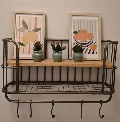 a shelf with two pictures and some plants on it at De Smokkelhoeve in Riemst