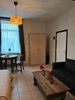 a living room with a couch and a table at De Smokkelhoeve in Riemst