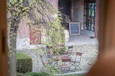 a view of a patio with chairs and a table at Domein Marsnil in Heers
