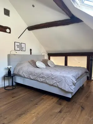 a bedroom with a bed and a wooden floor at Residence Saint Lambert in Plombières