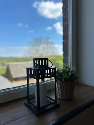 a small black side table sitting on a window sill at Residence Saint Lambert in Plombières