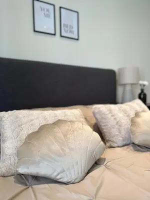 a bed with two pillows on top of it at Residence Saint Lambert in Plombières