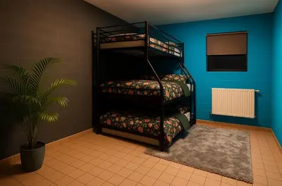 a room with three bunk beds and a plant at L'appart en gare in Welkenraedt
