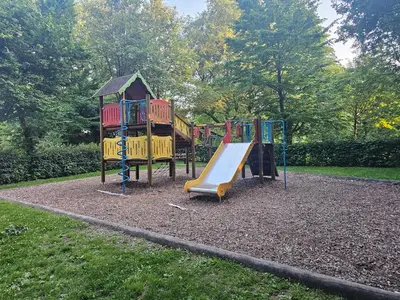 a playground with a slide in a park at L'appart en gare in Welkenraedt