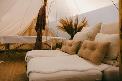 a living room with two couches and a tent at Essential by cin in Zonhoven