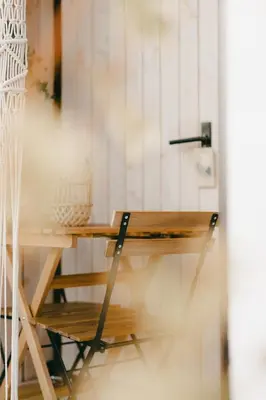 a wooden desk with a chair next to a wall at Essential by cin in Zonhoven