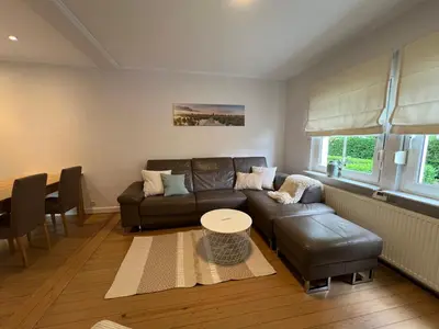 a living room with a couch and a table at Cottage CaLoMa in Eupen