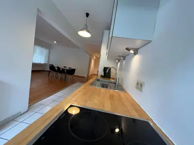 a kitchen with a counter top and a dining room at Alexis's loft 2 in Liège