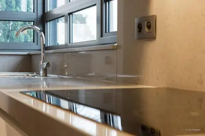 a kitchen counter with a sink and a window at 14 beds, 20p, 2 bath-, 1 livingroom in Houthalen-Helchteren